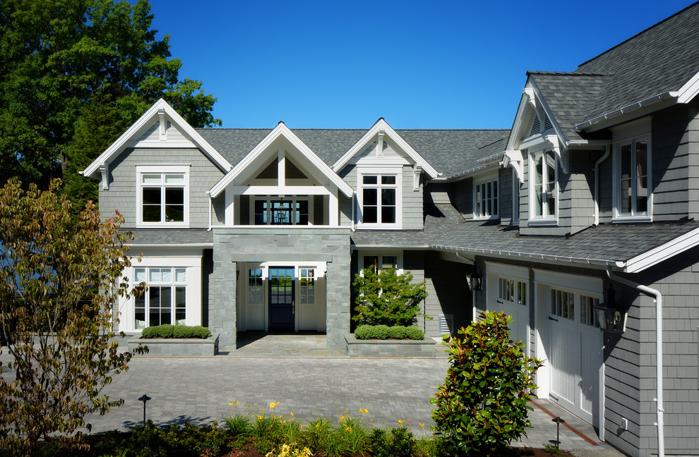 На фото: двухэтажный, деревянный, серый, большой частный загородный дом в классическом стиле с крышей из гибкой черепицы