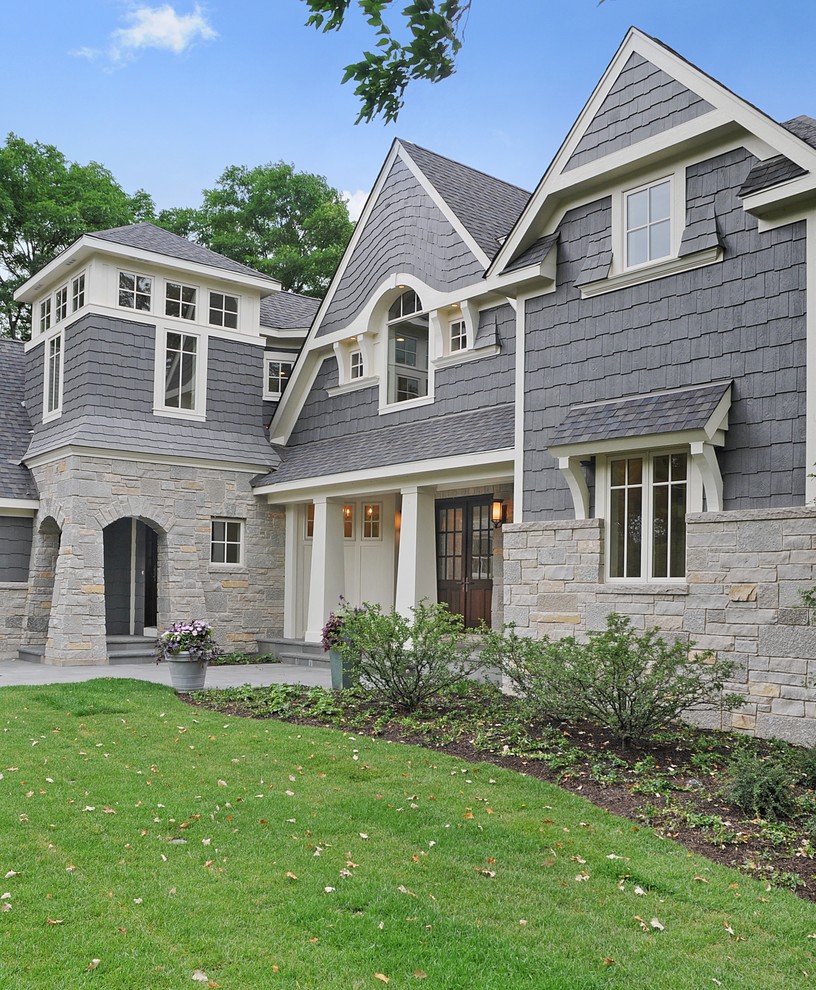 Example of a large classic gray three-story mixed siding exterior home design in Chicago with a shingle roof