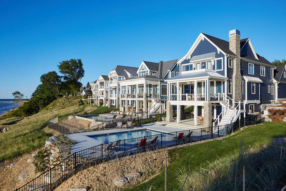 Beach style blue three-story wood exterior home photo in Grand Rapids with a shingle roof