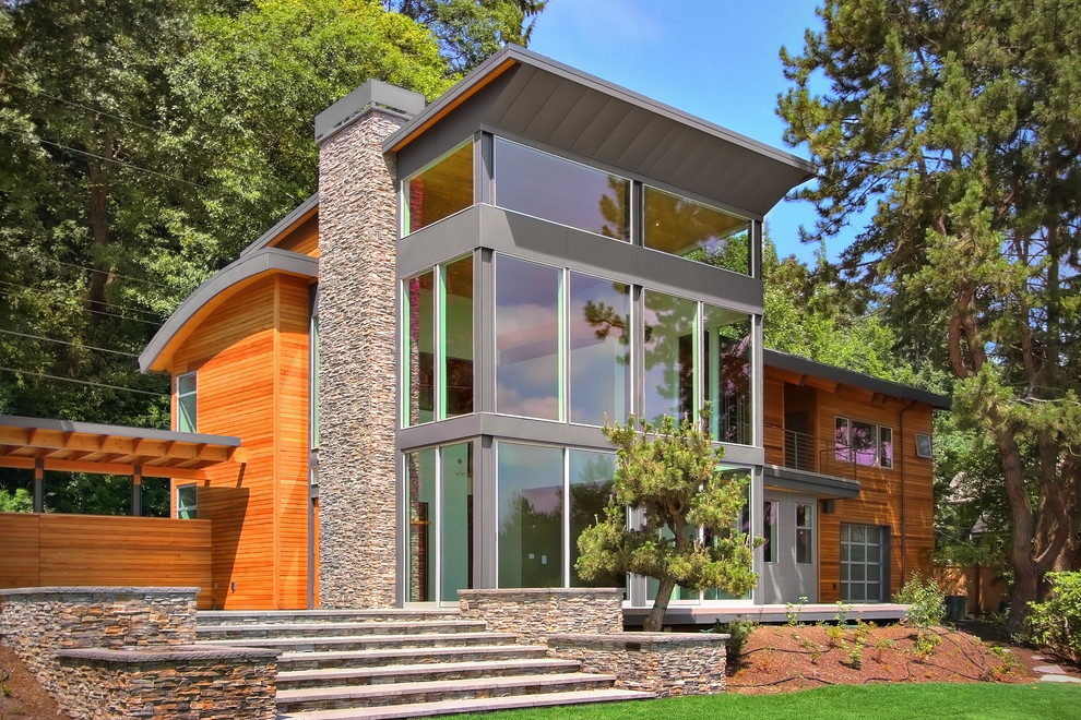 Large trendy brown two-story wood exterior home photo in Seattle