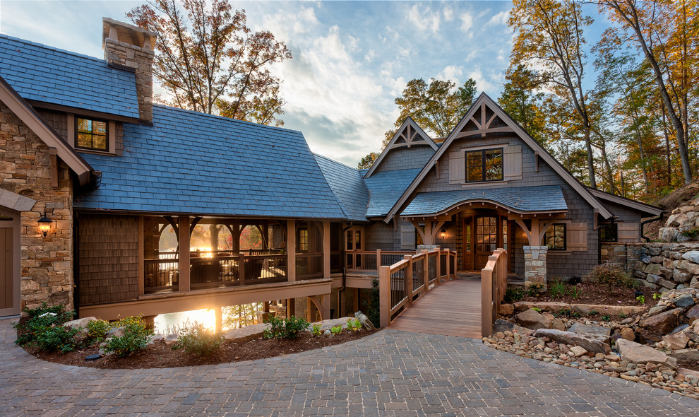 Inspiration for a large timeless brown two-story wood gable roof remodel in Other