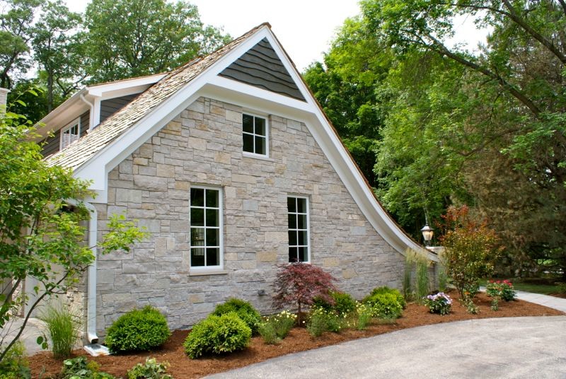 Elegant gray two-story stone gable roof photo in Chicago
