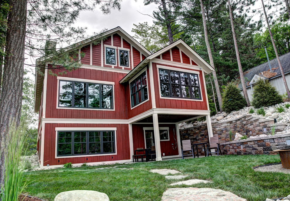 Mid-sized arts and crafts red two-story wood exterior home photo in Grand Rapids