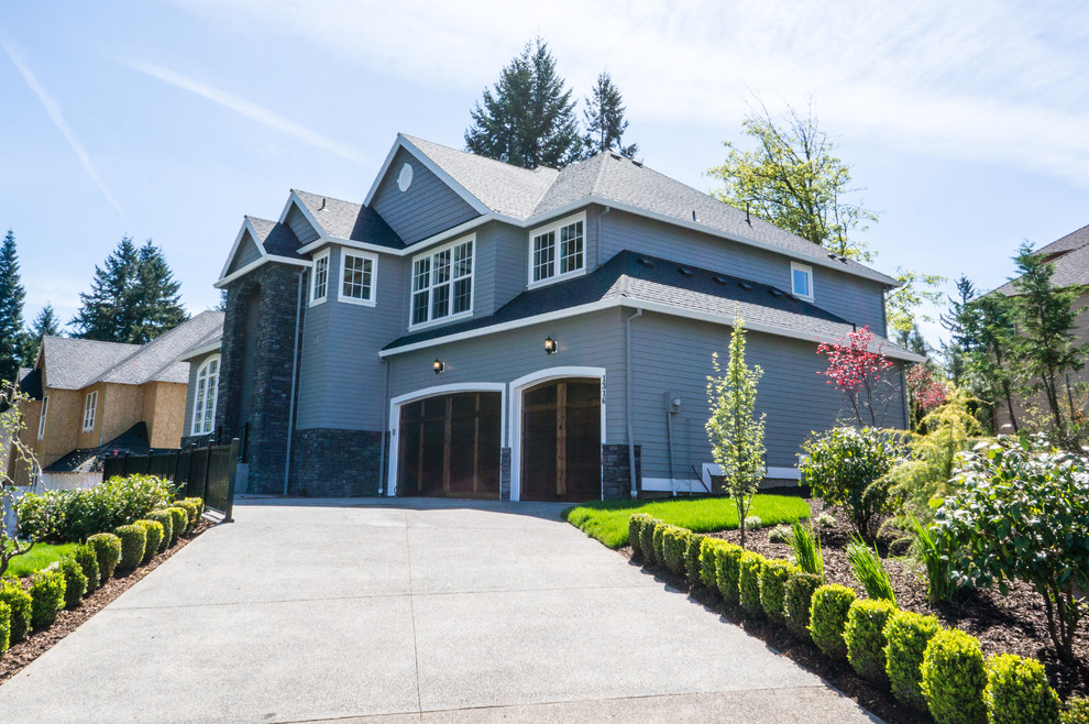 Large elegant gray two-story concrete fiberboard exterior home photo in Portland