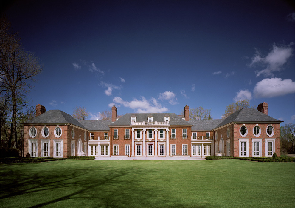 Example of a huge classic three-story brick exterior home design in Detroit