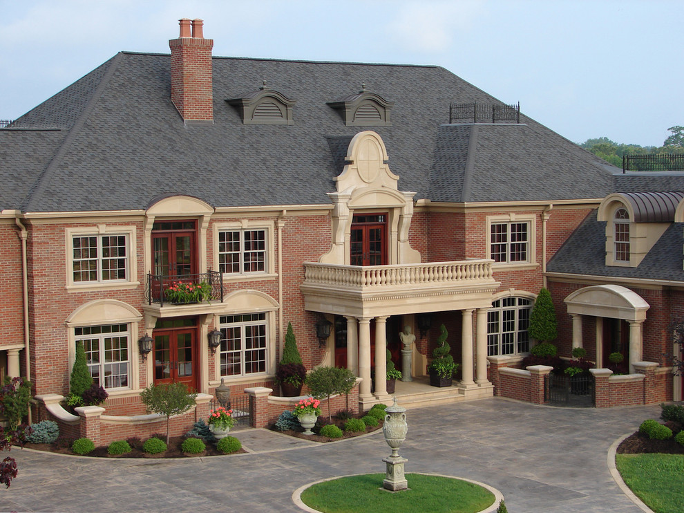 Example of a huge classic red three-story brick house exterior design in New York with a hip roof and a shingle roof