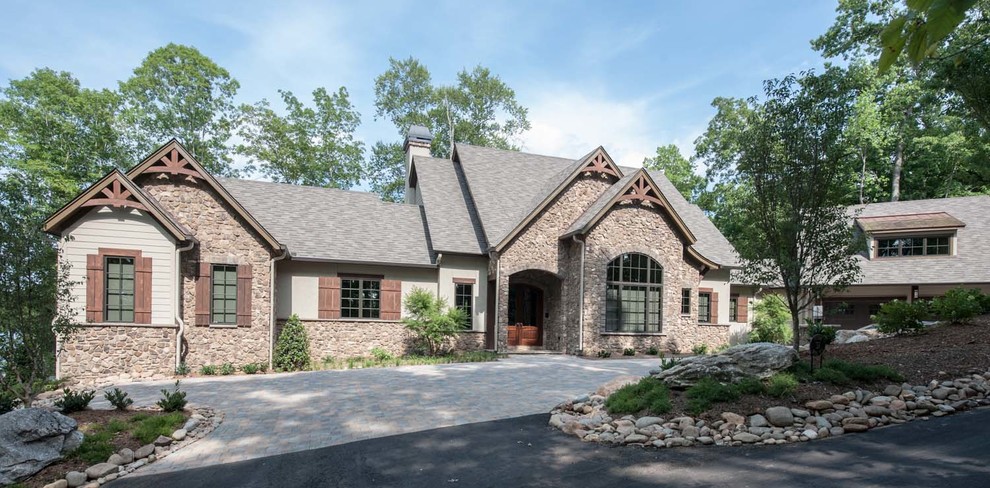 Mid-sized transitional beige one-story stone gable roof idea in Other