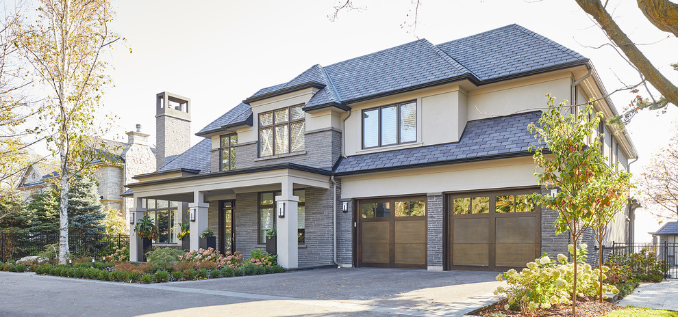 Photo of a large and gey traditional two floor detached house in Toronto with stone cladding.
