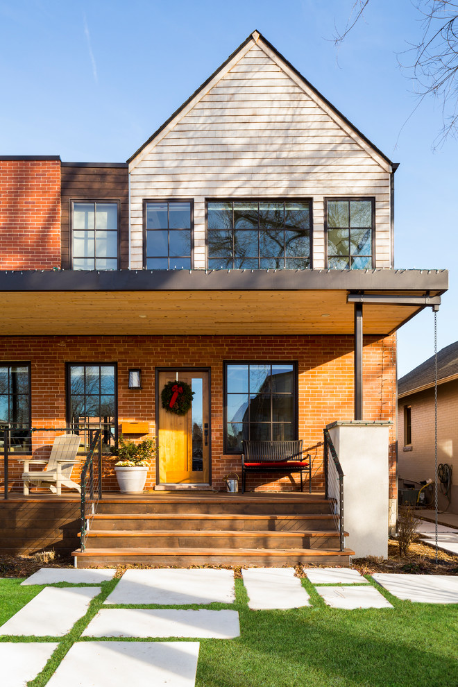 Example of a mid-sized minimalist gray two-story brick exterior home design in Denver with a mixed material roof
