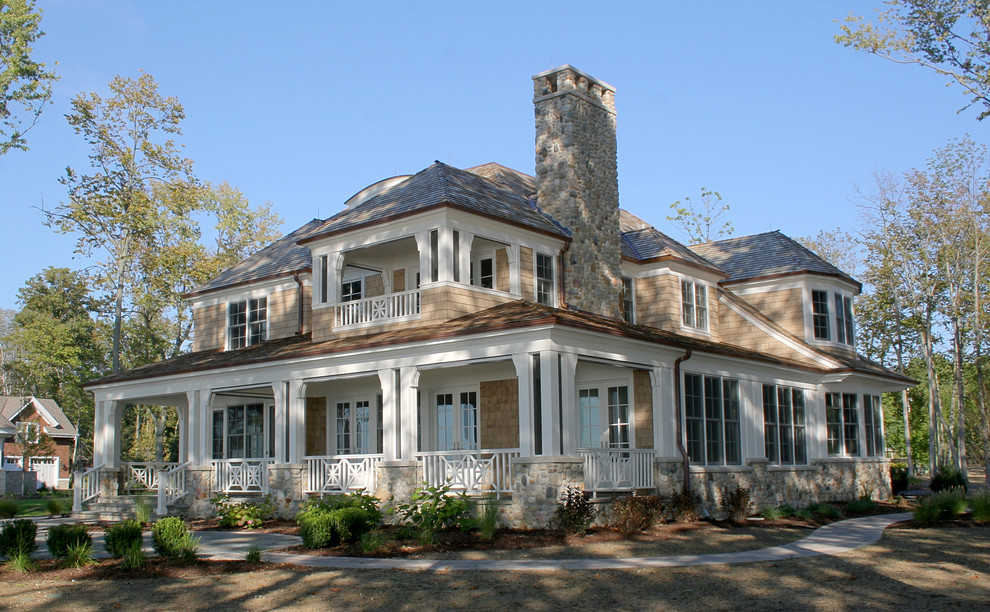 Inspiration for a large timeless beige two-story wood house exterior remodel in Grand Rapids with a hip roof and a shingle roof
