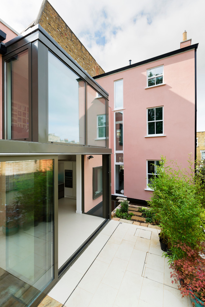 Contemporary house exterior in London with a pink house.