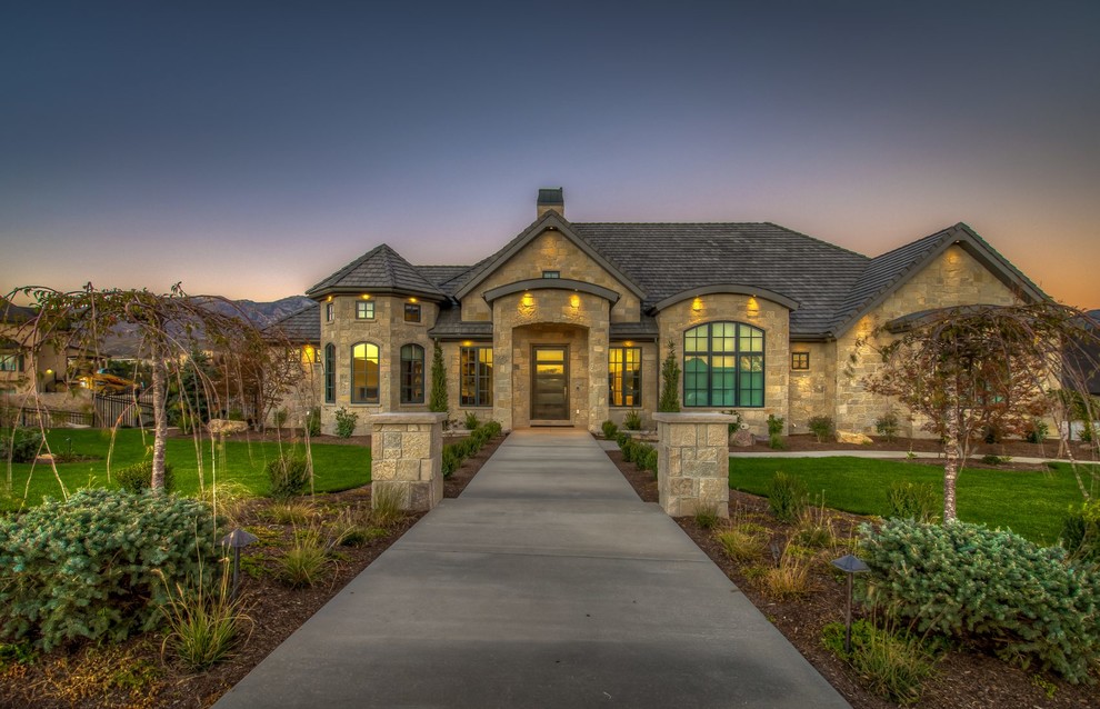 This is an example of an expansive and beige rustic detached house in Salt Lake City with three floors, stone cladding, a hip roof and a shingle roof.