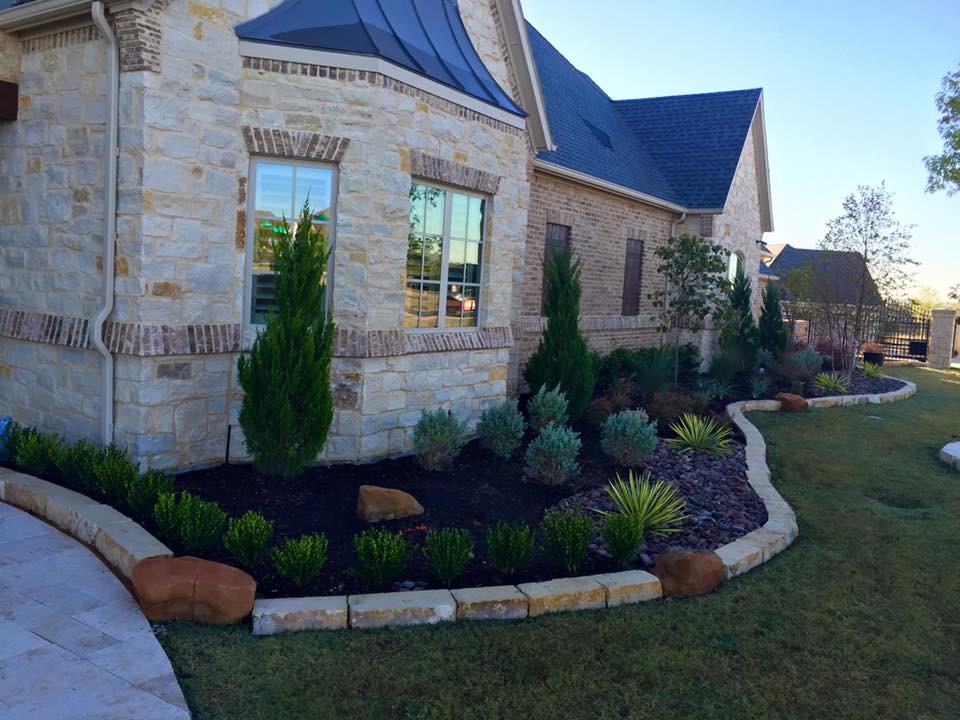 This is an example of a medium sized and beige classic two floor house exterior in Dallas with stone cladding.