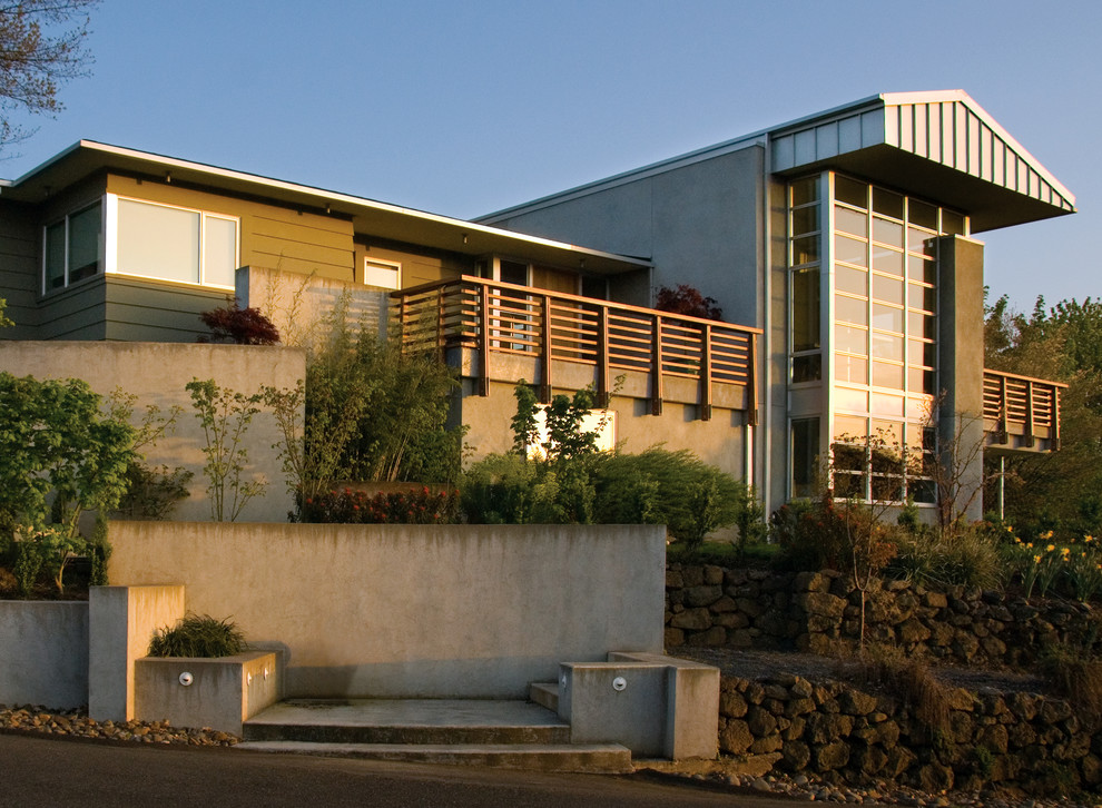This is an example of a green and large contemporary house exterior in Portland with three floors and mixed cladding.