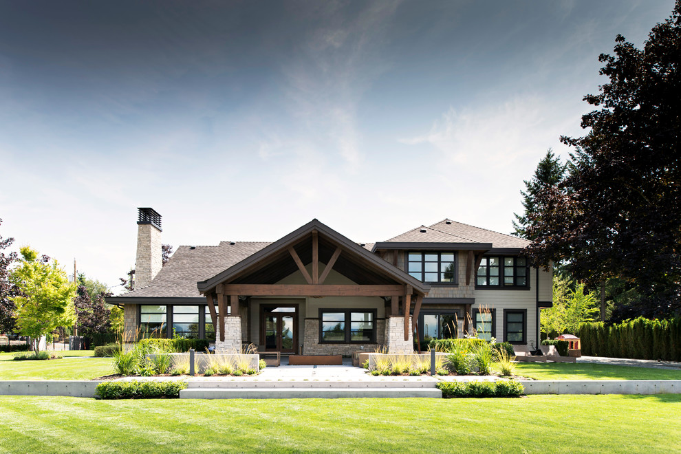 Large rustic two floor house exterior in Vancouver with wood cladding and a hip roof.