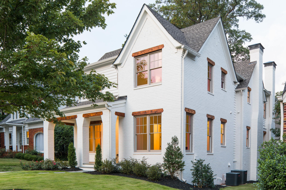 This is an example of a medium sized and white traditional detached house in Atlanta with three floors, wood cladding, a pitched roof and a shingle roof.