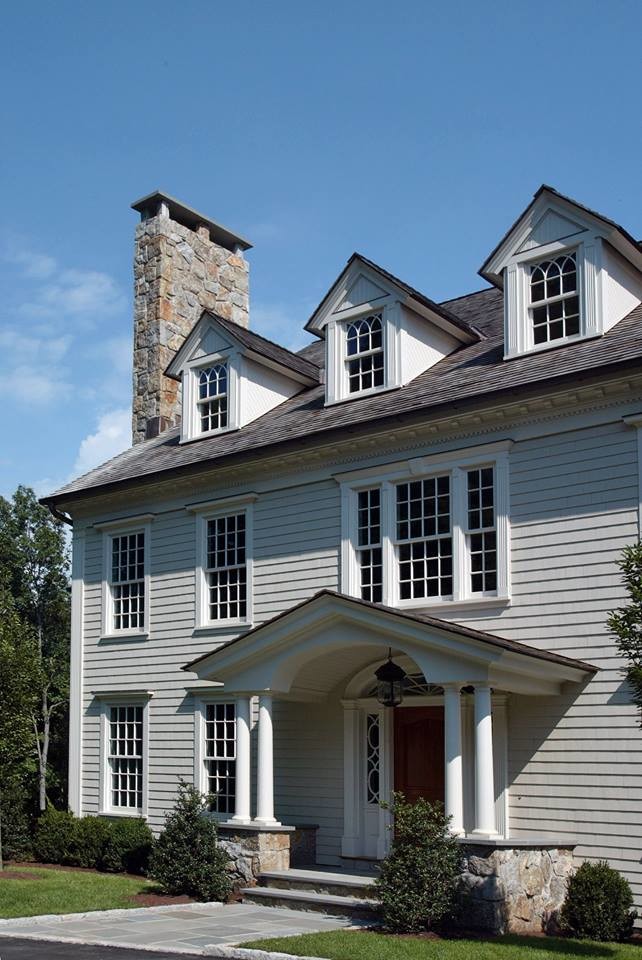 Example of a transitional gray two-story stone exterior home design in New York