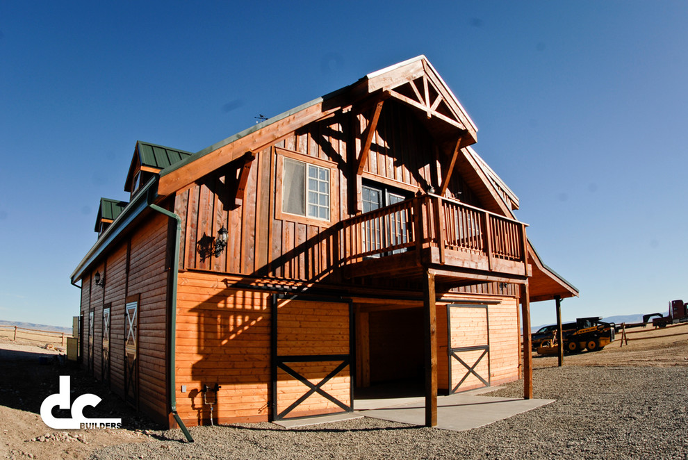 Photo of a large and brown rustic two floor house exterior in Denver with wood cladding and a pitched roof.