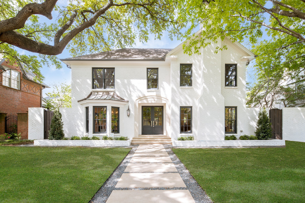 Transitional white two-story brick exterior home idea in Dallas with a shingle roof
