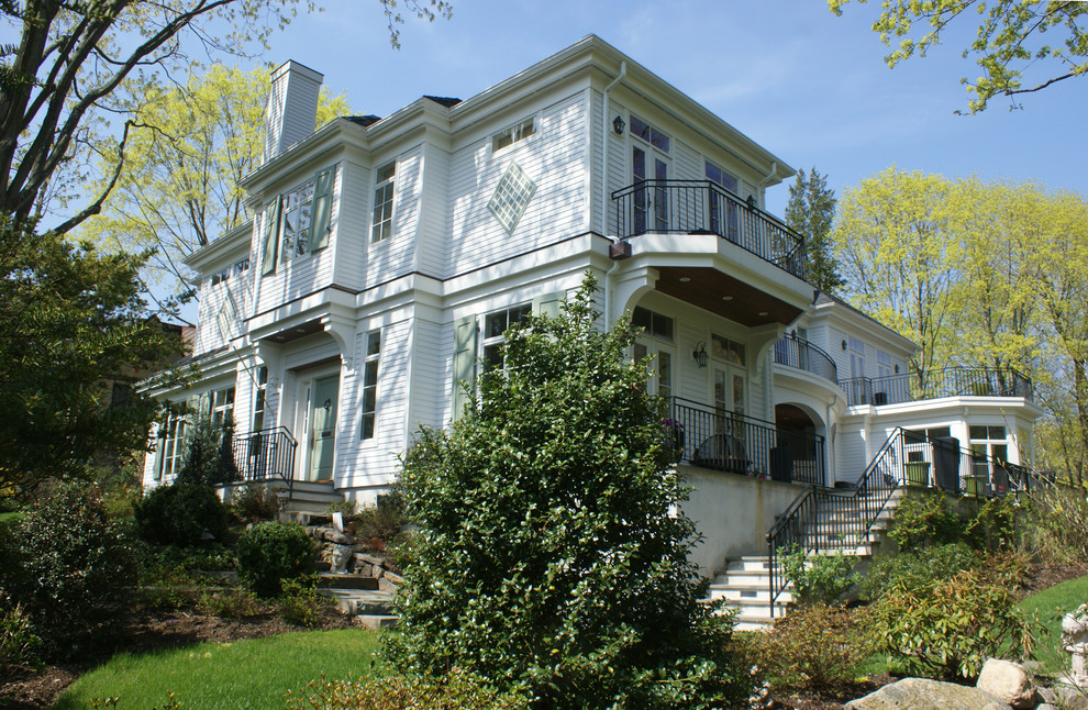 Example of a large classic white two-story wood house exterior design in New York