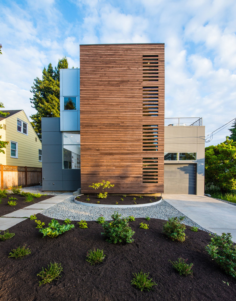 Trendy two-story mixed siding flat roof photo in Seattle