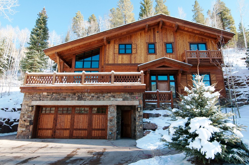 Inspiration for a large timeless brown three-story wood gable roof remodel in Denver