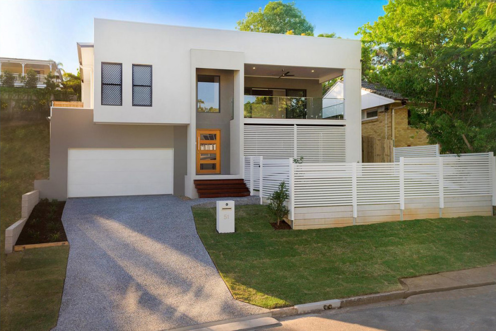 This is an example of a medium sized and white contemporary split-level detached house in Brisbane with mixed cladding, a lean-to roof and a metal roof.