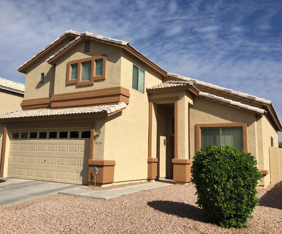 Mid-sized transitional beige two-story stucco house exterior idea in Phoenix with a hip roof and a tile roof