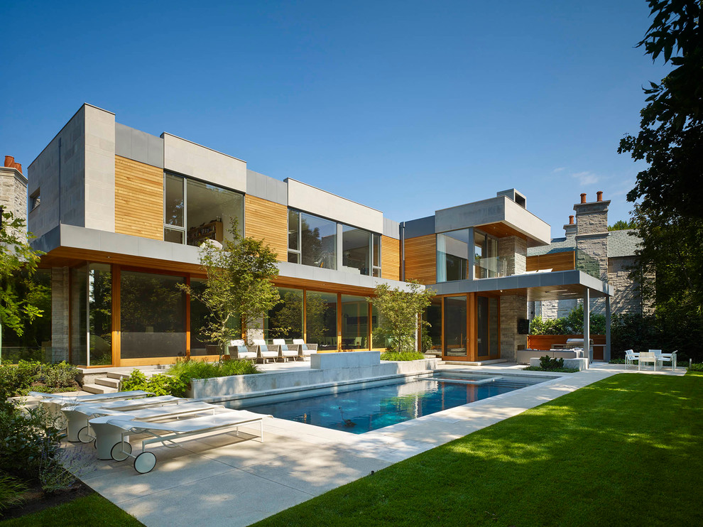 Inspiration för stora moderna grå hus, med två våningar, platt tak och blandad fasad