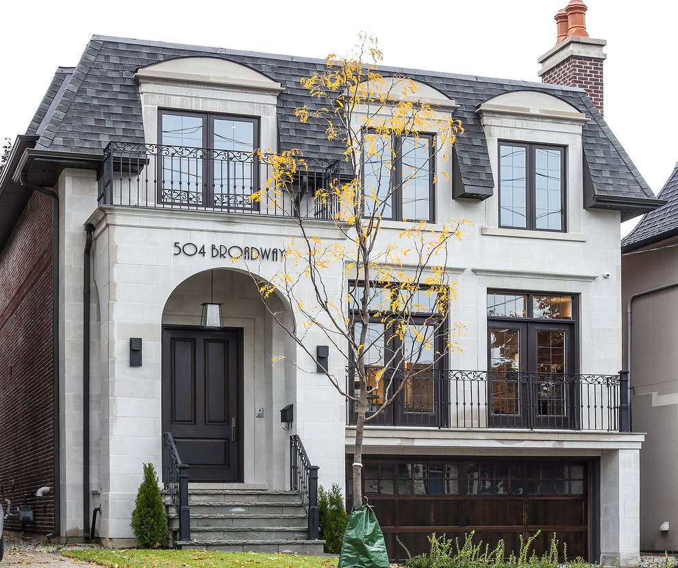 Large transitional white stone exterior home idea in Toronto