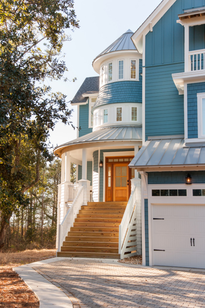 Large beach style blue three-story mixed siding house exterior photo in Other with a mixed material roof