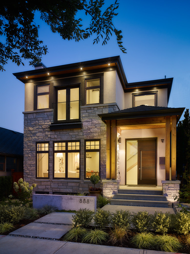 Small contemporary two floor house exterior in Vancouver with mixed cladding.