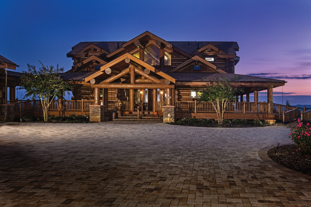 Example of a large mountain style brown three-story wood exterior home design in Charlotte