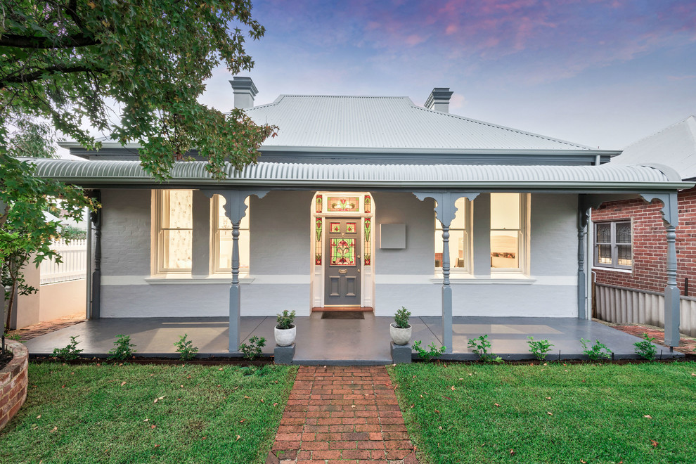Example of a transitional white one-story exterior home design in Perth with a hip roof and a metal roof