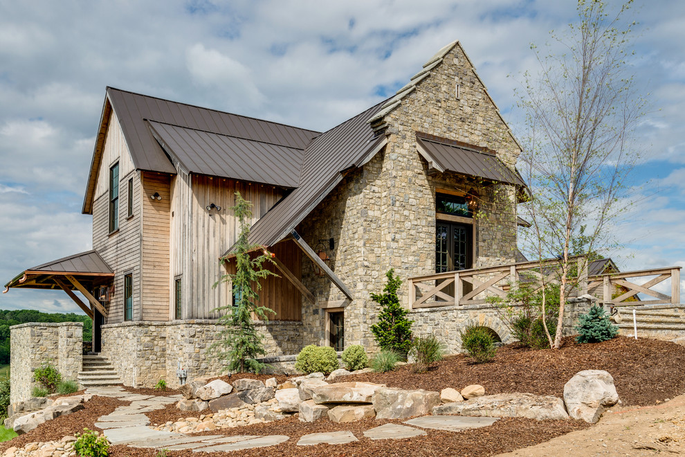 Photo of a rustic two floor detached house in Nashville with mixed cladding, a pitched roof and a metal roof.