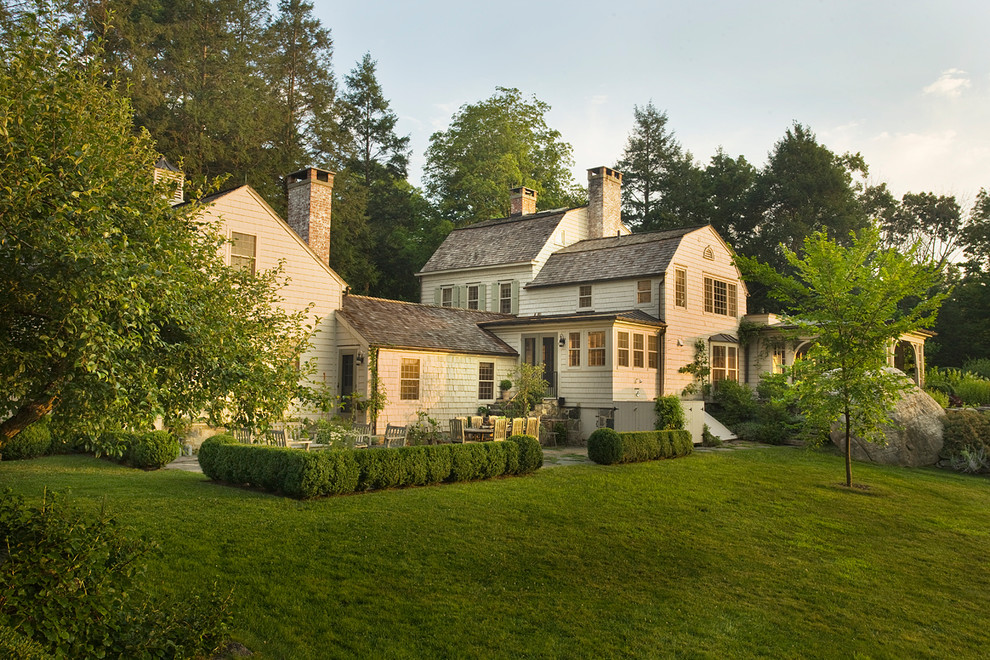 Cottage white two-story wood house exterior idea in New York with a gambrel roof and a shingle roof