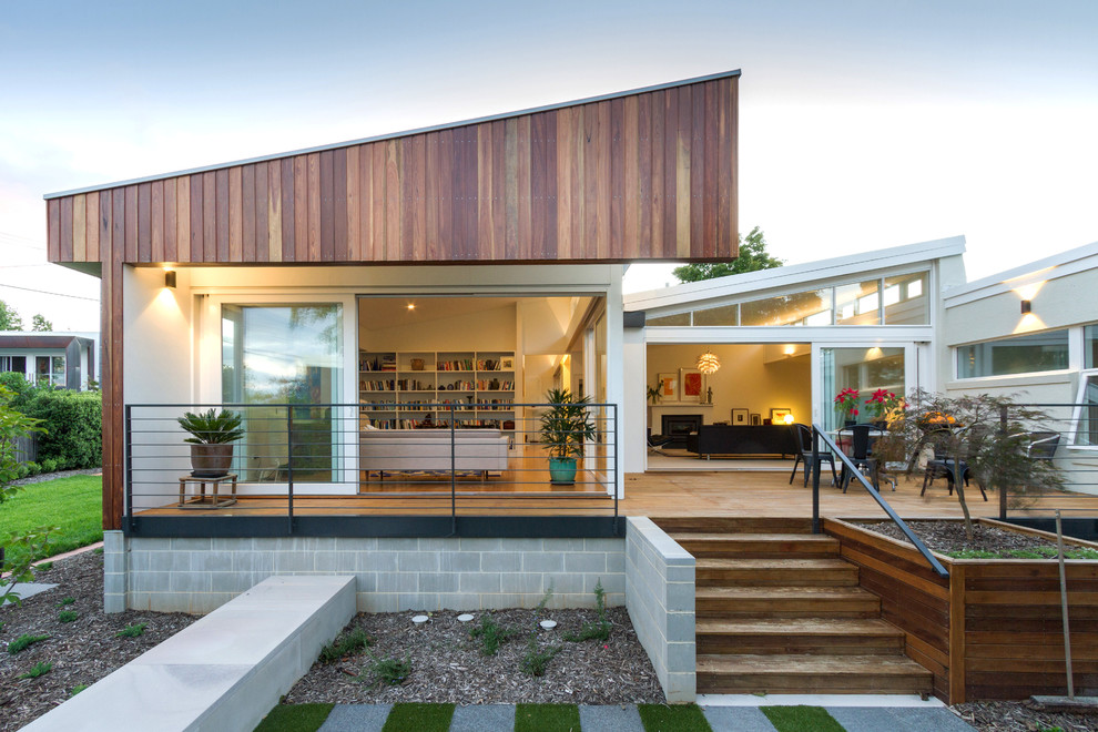 This is an example of a beige contemporary house exterior in Canberra - Queanbeyan.