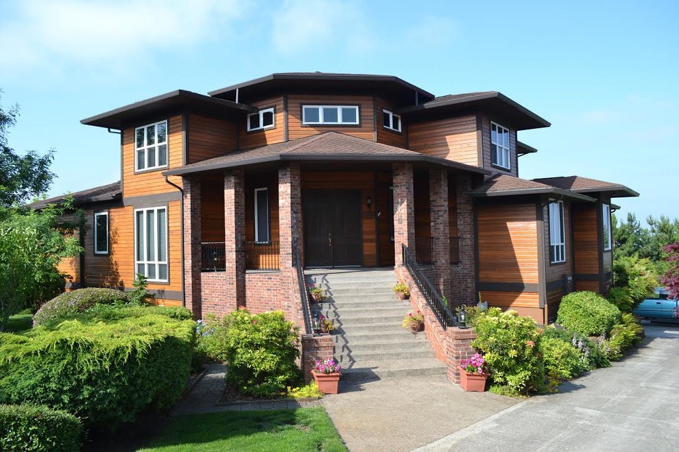 Пример оригинального дизайна: большой, двухэтажный, коричневый частный загородный дом в стиле модернизм с комбинированной облицовкой