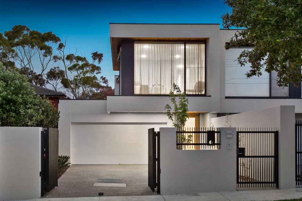 Große, Zweistöckige Moderne Doppelhaushälfte mit Betonfassade, grauer Fassadenfarbe, Flachdach und Misch-Dachdeckung in Melbourne