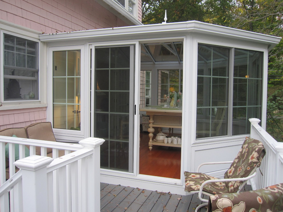 Design ideas for a medium sized and white shabby-chic style bungalow house exterior in Boston with vinyl cladding.