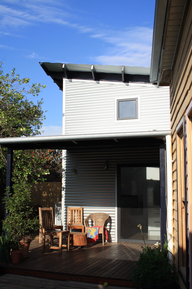Kleines, Einstöckiges Modernes Einfamilienhaus mit Metallfassade, grauer Fassadenfarbe, Flachdach und Blechdach in Melbourne