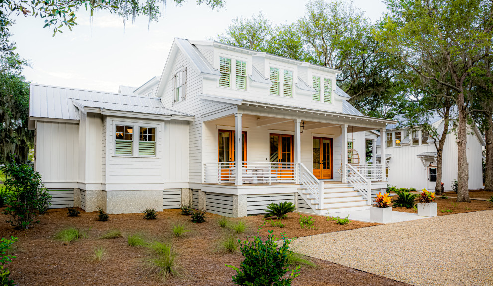 Inspiration for a cottage white two-story exterior home remodel in Atlanta with a metal roof