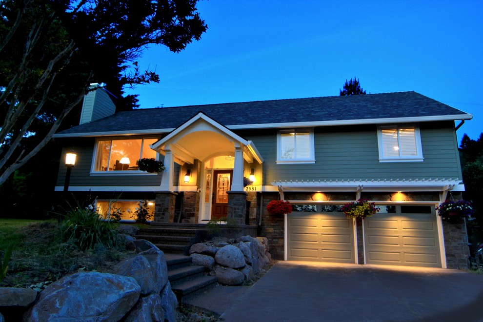 Inspiration for a large timeless green split-level mixed siding exterior home remodel in Portland with a shingle roof