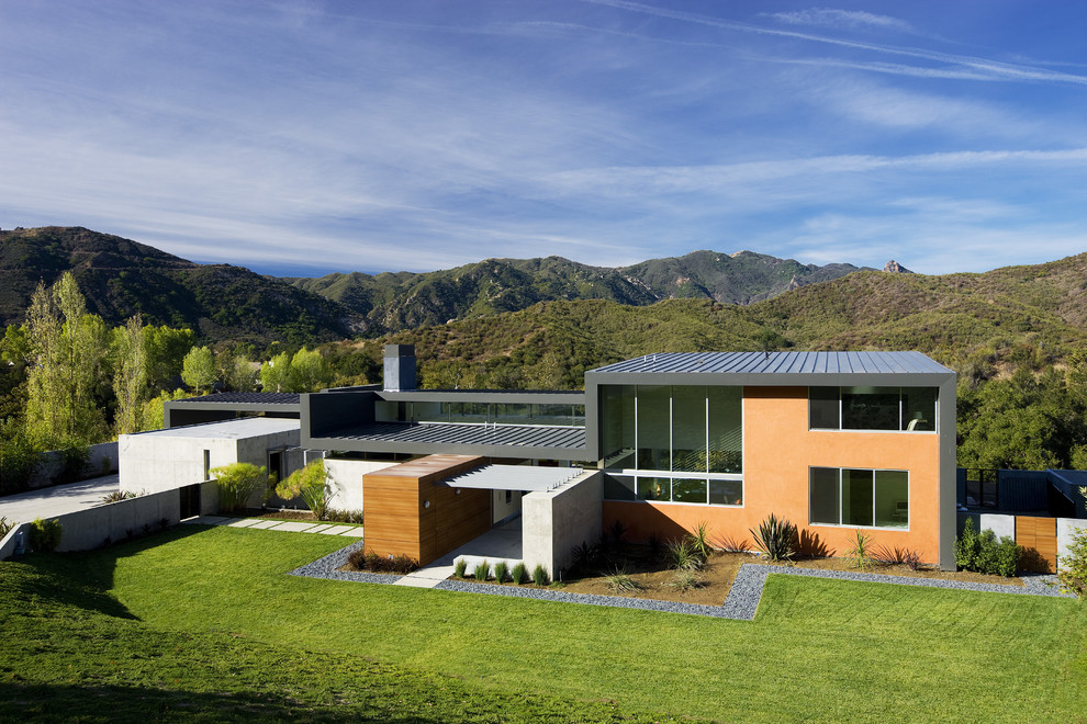 Inspiration pour une grande façade de maison métallique et grise minimaliste à un étage avec un toit plat.