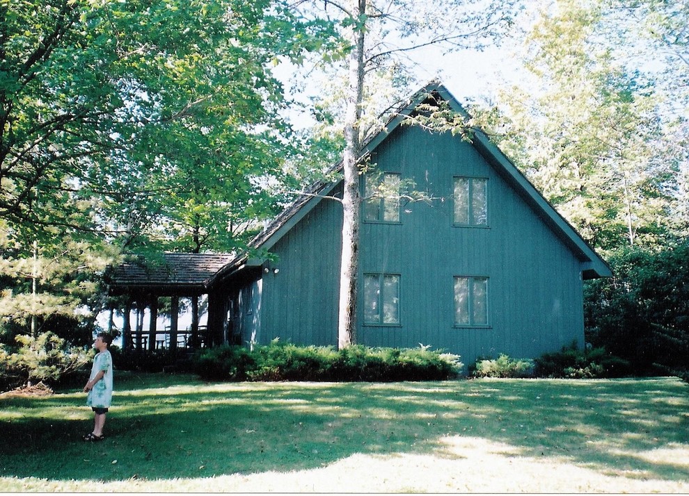 Example of a mid-sized country white two-story concrete fiberboard gable roof design in Other