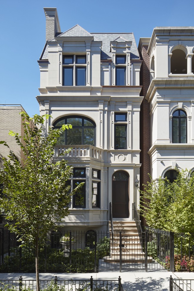 Example of a huge transitional three-story stone gable roof design in Chicago