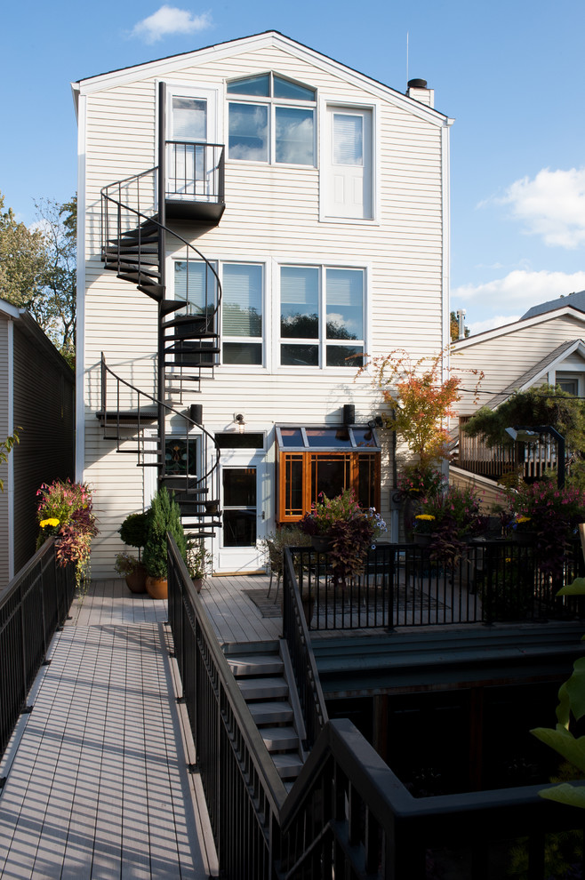 This is an example of a white traditional house exterior in Chicago with three floors.