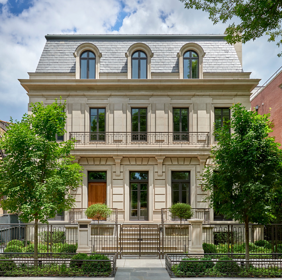 This is an example of an expansive and gey traditional detached house in Chicago with three floors, stone cladding, a pitched roof and a shingle roof.