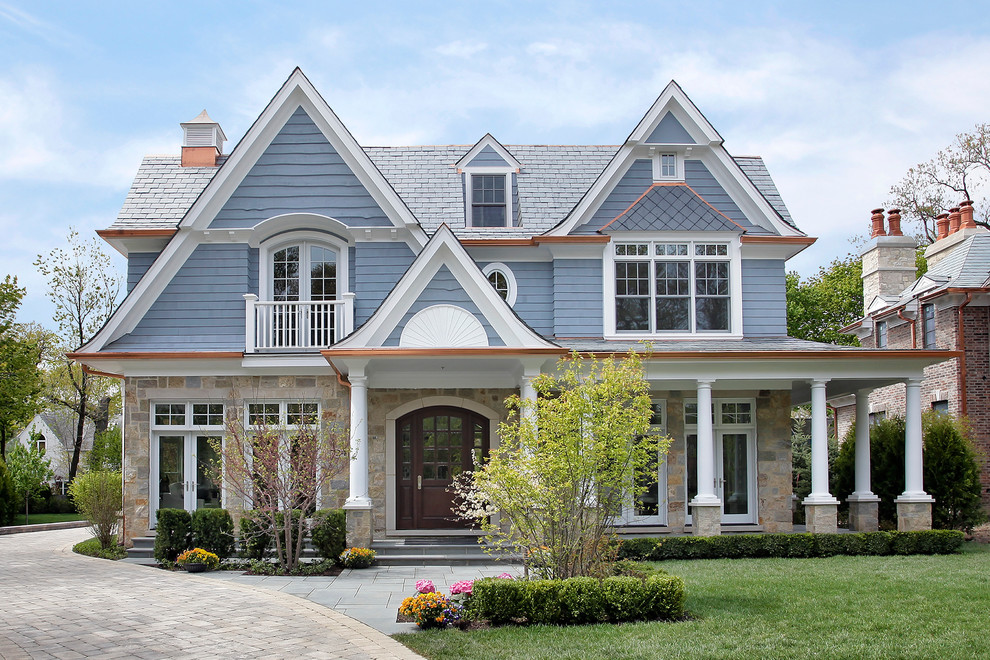 Inspiration for a traditional house exterior in Chicago with stone cladding.