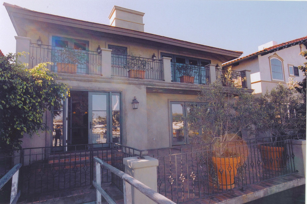 Photo of a beige and large traditional two floor render house exterior in Orange County.